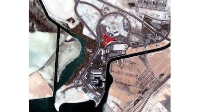 As this satellite photo shows, the distinctive red Ferrari World in Abu Dhabi, centre, and even its yellow prancing horse logo, is one of the man-made structures in the UAE that can be seen from space. Courtesy Emirates Institution for Advanced Science and Technology