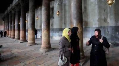 Muslim women stand in the Church of the Nativity in Bethlehem. Thousands more Palestinians and tourists have flocked to the birthplace of Jesus Christ to mark Christmas.