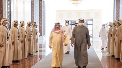 King Hamad of Bahrain walks with the President, Sheikh Mohamed. Hamad Al Kaabi / Ministry of Presidential Affairs