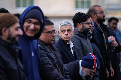 Sadiq Khan, Mayor of London, centre, joins a prayer before an Open Iftar Ramadan dinner in Trafalgar Square, London. EPA