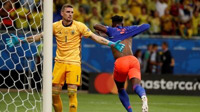 Colombia's Duvan Zapata celebrates after scoring against Argentinian goalkeeper Franco Armani. EPA
