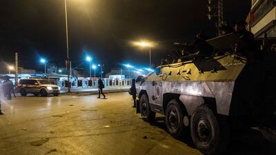 A riot policemen stand next to an amoured vehicle in Tunis. Amine Landoulsi /AP Photo