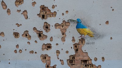 Work by street artist Tvboy on a wall of the House of Culture in Irpin, near Kyiv, which was heavily damaged during a Russian attack on Ukraine. Reuters