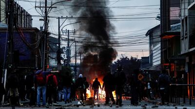 Demonstrators stand next to a burning barricade during anti-government protests, in Concepcion, Chile. Reuters