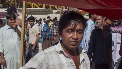 Bangladeshi Joy Shargat, a worker in a marble company, fries jalebies every Friday at a market set up outside the labour camp to earn some money. Mona Al-Marzooqi/ The National