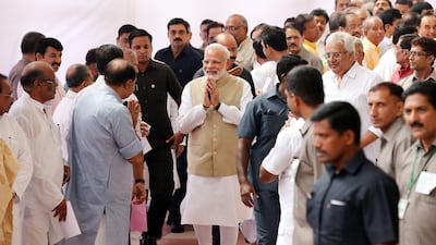Indian prime minister Narendra Modi (C) greets Indian lawmakers after casting his vote at Parliament House during the presidential election in New Delhi on Monday. EPA / Harish Tyagi