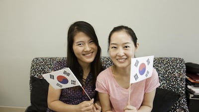 World Cup fans from South Korea, Yoonhee Choi (right) and Eunyoung Jin prepare to cheer their team on. Jaime Puebla / The National