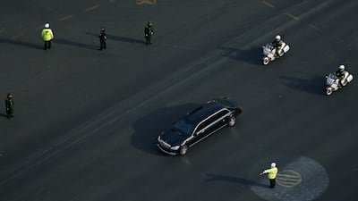 A Mercedes limousine with a golden emblem, similar to one Kim Jong-un has used previously, is escorted by motorcades travelling past Chang'an Avenue in Beijing. AP Photo