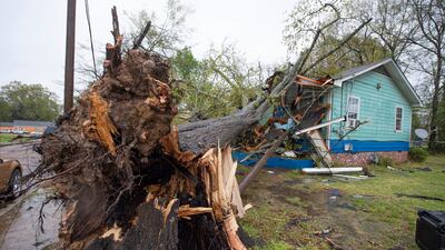 A house on Summer Street in Jackson, Mississippi, was heavily damaged by a downed tree during severe weather that moved through the city on Wednesday, March 30, 2022. The Clarion-Ledger / AP