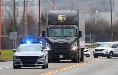 Kentucky State Police escort a UPS truck carrying Moderna's Covid-19 vaccine as it arrives at UPS Worldport, in Louisville, Kentucky, December 20, 2020. Reuters