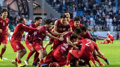 Vietnam players celebrate their success after beating Jordan on penalties. All images by Antonie Robertson / The National