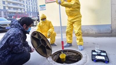 Workers of the ecology and environment bureau collect samples from the sewage system of a hospital following an outbreak of the novel coronavirus in the country, in Xinle, Hebei province, China. REUTERS