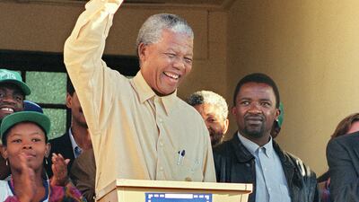 African National Congress (ANC) President Nelson Mandela smiles broadly 27 April 1994 in Oshlange, black township near Durban, as he casts his historic vote during South Africa's first democratic and all-race general elections.