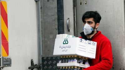 An Iranian worker carries medical supplies on a street of Tehran, Iran. EPA