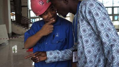 A Chinese worker jokes with his Nigerian counterpart at the National Arts Theatre stop of the light rail system under construction in Lagos, Nigeria. Joe Penney / Reuters