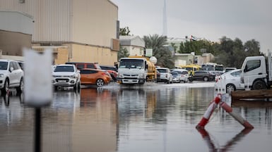 Drivers navigate a flooded road in Dubai's Al Quoz on Sunday, during the start of the current spell of adverse weather. Antonie Robertson / The National