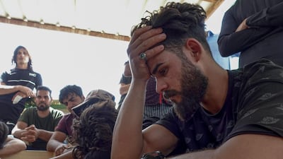 Iraqis transport coffins of relatives killed during a fire in a hospital in the capital, during their funeral in Najaf, April 25. AFP
