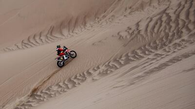 Honda's Portuguese biker Paulo Goncalvez rides up a dune. AFP