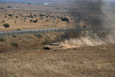 An Israeli tank drives along the ceasefire line between the Israeli-occupied Golan Heights and Syria, on its Israeli side. Reuters