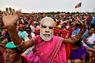 A woman wearing a Narendra Modi mask at a campaign rally in the north-eastern state of Assam. Reuters