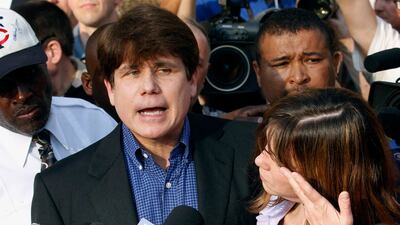 Former Illinois governor Rod Blagojevich speaks to the media outside his home in Chicago on March 14, 2012, as his wife, Patti, wipes away tears a day before reporting to prison after his conviction on corruption charges. AP