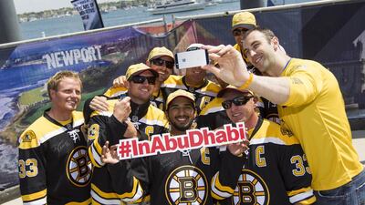 Abu Dhabi Ocean Racing crew don Boston Bruins jerseys alongside Bruins player Zdeno Chára, who joined the crew during the in-port race. Photo courtesy: Abu Dhabi Ocean Racing