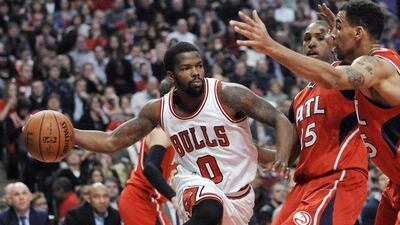 Chicago Bulls' Aaron Brooks (0) passes around Atlanta Hawks' Al Horford (15) and Thabo Sefolosha (25) during the second half of an NBA basketball game in Chicago on January 17. Atlanta won 107-99. Paul Beaty/AP