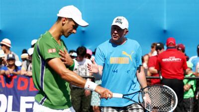 Novak Djokovic of Serbia and his coach Boris Becker take part in a practice session. Matt King / Getty Images