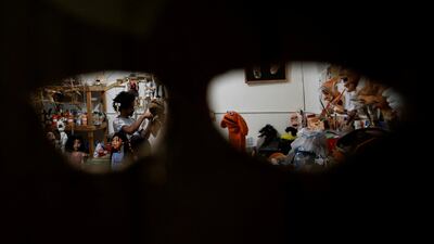 Puppeteer Mohamed Fawzy Bakkar's workshop in Cairo, Egypt's capital, seen through a hand-made mask. Reuters