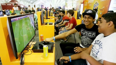 People play FIFA 2016 at the Fanta booth during Games 15 Middle East at the International Marine Club in Dubai. Christopher Pike / The National