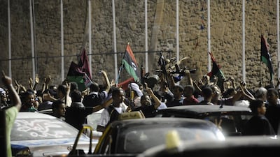 Rebel fighters and civilians celebrate in the newly named Martyr's Square, formerly known as Green Square, after rebel forces overran Libyan leader Moamer Kadhafi's fortified Bab al-Azizya headquarters in the capital Tripoli, following heavy fighting on August 23, 2011. AFP PHOTO/FILIPPO MONTEFORTE *** Local Caption *** 666764-01-08.jpg