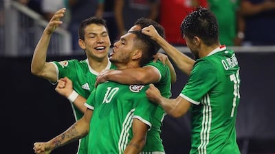Jesus Manuel Corona, centre, celebrates with his Mexico teammates. Scott Halleran / Getty Images