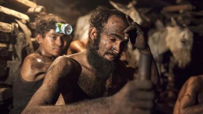A miner wipes sweat from his forehead inside a coal mine in Choa Saidan Shah, Punjab. Sara Farid / Reuters