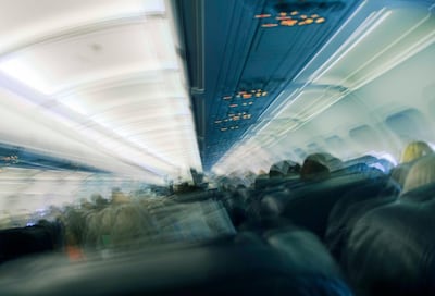Seated passengers in aeroplane cabin. Getty Images