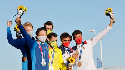 Silver medalists Fredrik Bergstrom and Anton Dahlberg of Sweden, gold medalists Mathew Belcher and Will Ryan of Australia and bronze medalists Nicolas Rodriguez Garcia-Paz and Jordi Xammar of Spain pose after the Men's Two Person Dinghy medal race.