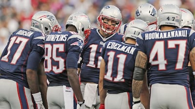 With so many new receivers in the huddle perhaps New England Patriots should consider printing their names on the front, too, so quarterback Tom Brady, center, has an easier time of identifying them. Winslow Townson / Getty Images