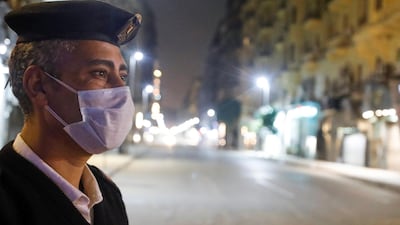 A police officer stands at the Qasr El Nil street during the first day of a two-week night-time curfew which was ordered by the Egyptian Prime Minister Mostafa Madbouly to contain the spread of the coronavirus disease, in Cairo, Egypt. Reuters