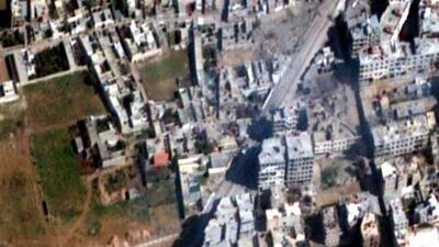 Residential and commercial buildings along the main road between Mezzeh Air Base and Daraya, a Damascus, Syria suburb on February 4, 2013. Human Rights Watch via Digital Globe / AP Photo
