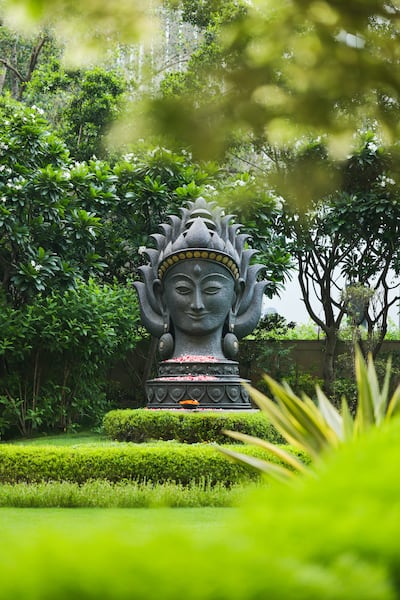 An 11ft Devi sculpture stands in the gardens. Photo: Leela Palacd