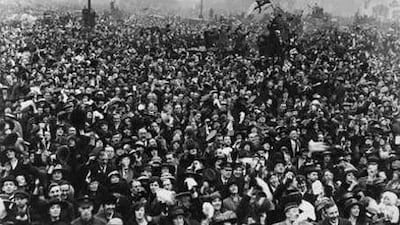 Jubilant crowds close to Buckingham Palace celebrate Armistice Day on November 11, 1918.