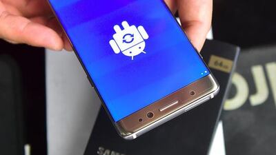 A South Korean employee resets a recalled Samsung Galaxy Note7 at a phone shop in Seoul. Jung Yeon-Je / AFP