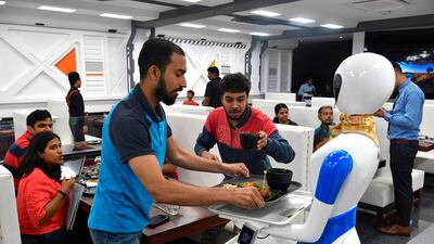 A service robot delivers food to customers. AFP