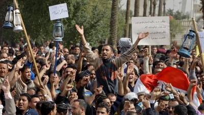 Demonstrators carry oil lanterns, to protest at the lack of electricity, while they chant anti-Iraqi government slogans during a protest at Tahrir Square in Baghdad.