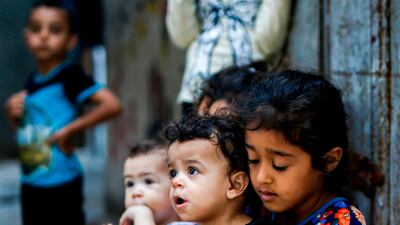 A girl carries a young child near their home at al-Shati camp for Palestinian refugees in the central Gaza Strip. June 20 marks World Refugee Day, a day dedicated by the United Nations General Assembly to raising awareness of the situation of refugees throughout the world. Some five million individuals are refugees registered with the UN Relief and Works Agency for Palestine Refugees (UNRWA), of whom more than 1.5 million (nearly one-third) live in 58 recognised refugee camps in the Gaza Strip and the West Bank including East Jerusalem, in addition to Jordan, Lebanon, and Syria. Palestine refugees are defined by the UNRWA as "persons whose normal place of residence was Palestine during the period 1 June 1946 to 15 May 1948, and who lost both home and means of livelihood as a result of the 1948 conflict." AFP