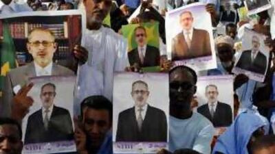 Supporters of Sidi Ould Cheikh Abdallahi, the ousted president, display his portrait during an anti-coup rally.