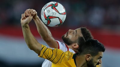 Australia's Aziz Behich, foreground, challenges for the ball with Syria's Mahmoud al Maowas. AP Photo