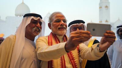 Indian Prime Minister Narendra Modi, centre, takes a selfie with Sheikh Nahyan bin Mubarak and Dr Anwar Gargash during his 2015 visit to the Sheikh Zayed Grand Mosque. AP Photo