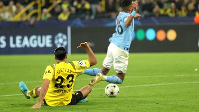 Borussia Dortmund's Emre Can fouls Manchester City's Riyad Mahrez to concede a penalty during the Champions League draw in Dortmund on October 25, 2022. EPA
