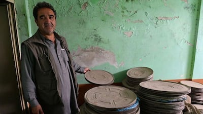 Mohammad Karim Aryobwal, with some of the dusty film reels.