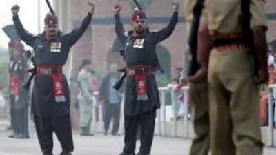 Pakistani Rangers (in black) and Indian Border Security Force personnel perform the daily retreat ceremony at the Wagah border.